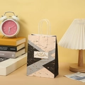 Detail of marble pattern gift bag with gold floral accent in a cozy lifestyle setting - Pink Black Gray Geometric (236-4)