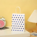 Close-up of white kraft gift bag with metallic blue polka dots and sturdy rope handles - White Base Blue Metallic Dots Handbag / Blue Dots/White Base