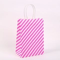 Sturdy pink and white diagonal striped kraft paper gift bag with white twist handles - L / Pink