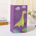 Detailed view of a purple paper gift bag featuring a cute green cartoon dinosaur design - Purple Dinosaur Cute Style