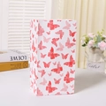 Sac cadeau vertical blanc avec motifs papillons rouges et roses sur une table blanche - Impression de Papillon (814) / Avec Autocollants
