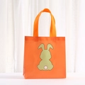 Close-up of orange non-woven shopping bag with cute green rabbit print and pink flower tail - 20*20*9 / Orange (9062-3)