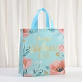 Detail of blue Mother's Day non-woven gift bag with pink floral patterns and gold lettering - Pink Flowers on Blue (5065-2) / 29*27*12