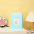 Close-up of light blue baby boy gift bag with white rope handles and stroller pattern - Light Blue Baby Boy Stroller Theme (101-1) / 21*15*8
