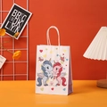 Detail of white paper gift bag with cute cartoon unicorns and twisted rope handles - Butterfly Unicorn (402-3)