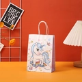 Detail of white unicorn gift bag with purple sides and rainbow stars on a desk - White Star Unicorn (401-2)