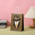 Close-up of a premium kraft paper gift bag with gold glitter gentleman silhouette - Gentleman Silhouette Wave Pattern Style (242-1)