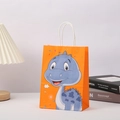 Detail of orange paper gift bag with blue dinosaur print and white rope handles - 21x15x5 / Orange