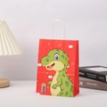 Detail of red kraft paper gift bag with green cartoon dinosaur and white rope handles - 21x15x5 / Red