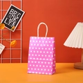 Detail of pink polka dot kraft gift bag with white twisted rope handle for birthdays - 15x11x6cm / Rose Pink