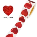 Macro detail of 1-inch red glitter heart stickers showing 2.5cm size measurement on roll - 25mm / Red