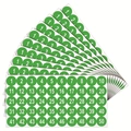 Macro detail of waterproof green round stickers numbered 1-50 with white bold font - Green