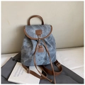 Detail of vintage canvas backpack with leather trim and adjustable drawstring straps - Blue