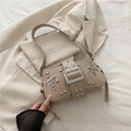 Retro beige motorcycle shoulder bag featuring silver rivets and metal buckle detail - Khaki
