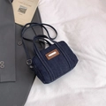 Detail of dark blue denim crossbody bag with contrast stitching and brown leather patch - Blue