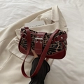 Leopard print underarm bag with deep red leather trim and silver metal buckles - Leopard Red