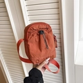 Waterproof nylon crossbody phone bag with drawstring pocket in orange red finish - Orange