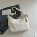 Beige corduroy crescent crossbody bag with adjustable strap and woven zipper detail - White