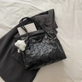 Black quilted tote bag with bear embossing, woven straps, and white cloud charm - Black With Pendant