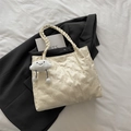 Quilted cream tote bag with bear pattern and cute cloud charm on black blazer background - Cream White with Pendant
