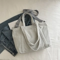 Minimalistische beige Cord-Tragetasche mit grauem Schultergurt für den Alltag - Hellgrau