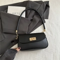 Minimalist black leather underarm bag with gold chain strap and woven metal turn-lock - Black