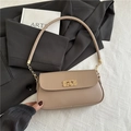 Minimalist beige small square shoulder bag with gold hardware on black blazer - Khaki