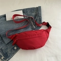 Red water-resistant nylon waist bag with adjustable strap and double zipper detail - Red