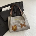 Grey canvas tote bag with brown leather straps and stylish puppy embroidery detail - Gray