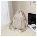 Detail of light beige nylon backpack featuring drawstring closure and metallic M logo - Off White