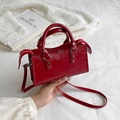 Glossy red faux leather motorcycle handbag with stylish rivet details and strap - Red