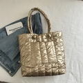 Quilted tote bag in metallic gold finish featuring large capacity and outer pocket - Gold