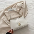 Minimalist beige underarm bag in premium faux leather with a golden gourd buckle accent - White