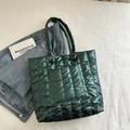 Deep green quilted puffer tote bag with metallic finish and metal ring hardware detail - Green