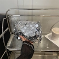 Chic silver sequin crossbody bag with chain strap on a modern urban lifestyle display - Silver