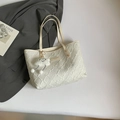 Chic beige quilted tote bag with textured surface and soft cloud charm in a flat lay - White With Pendant