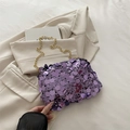 Fashionable purple sequin crossbody bag with gold chain strap on beige fabric - Purple