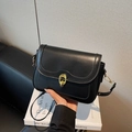 Classic black leather crossbody bag with golden ring buckle and adjustable strap - Black