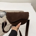 Dark brown suede saddle bag with curved flap and trendy wide woven shoulder strap - Brown