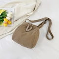 Khaki corduroy shell bag with dual zipper and woven pulls on white fabric background - Khaki