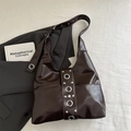 Deep burgundy shoulder bag with glossy finish and silver rivet metal eyelets design - Brown
