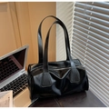 Detail of glossy black baguette shoulder bag featuring smooth leather and metal zipper - Black