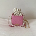 Detail of pink snake pattern mini bucket bag with pearl handle and drawstring closure - Pink