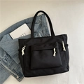 Black casual tote bag with white woven rope zipper pulls and multiple utility pockets - Black