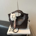Large dark brown woven leather tote bag with a white plush puppy charm and strap - With Plush Charm / Brown