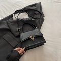 Minimalist black faux leather handbag with gold double-ring buckle and shoulder strap - Black