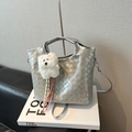 Silver woven handbag with plush puppy charm and metallic finish bucket bag design - With Plush Charm / Silver