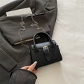 Chic black mini crossbody bag in matte leather with top handle and silver chain strap - Black