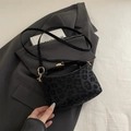 Fashionable black leopard print shoulder bag with gold hardware and plush fabric finish - Black
