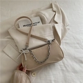 Beige matte underarm bag with thick silver chain and pearl bow charm on a blazer - Khaki